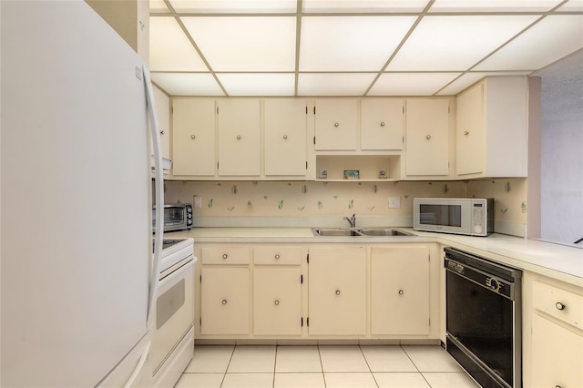 3047 S Atlantic Ave Unit 706, Daytona Beach, FL 32118 - kitchen with white appliances, cream cabinetry, a drop ceiling, light countertops, and open shelves