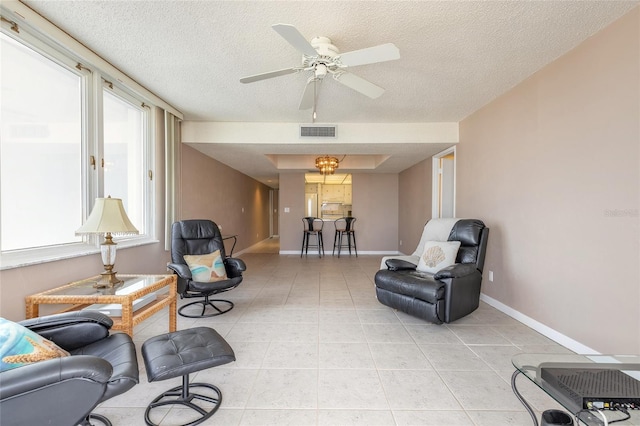 3047 S Atlantic Ave Unit 706, Daytona Beach, FL 32118 - living area with a textured ceiling, ceiling fan, and light tile patterned floors