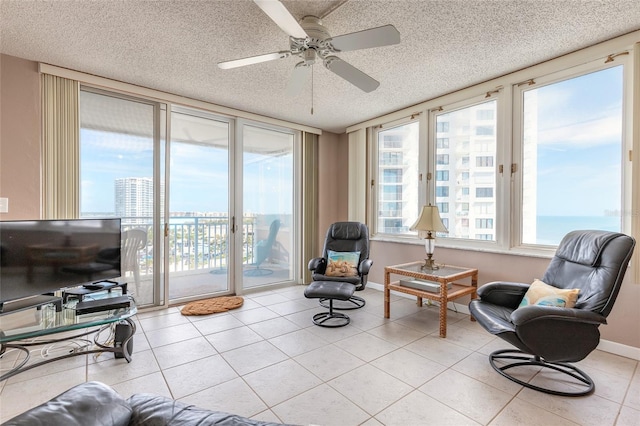 3047 S Atlantic Ave Unit 706, Daytona Beach, FL 32118 - sitting room featuring a textured ceiling, light tile patterned floors, and a ceiling fan