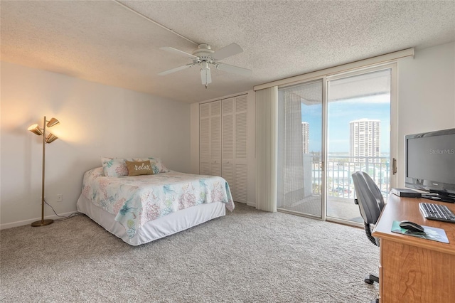 3047 S Atlantic Ave Unit 706, Daytona Beach, FL 32118 - carpeted bedroom with access to exterior, a desk, a textured ceiling, ceiling fan, and a closet