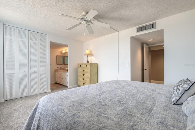 3047 S Atlantic Ave Unit 706, Daytona Beach, FL 32118 - bedroom with carpet flooring, a textured ceiling, a ceiling fan, connected bathroom, and a closet