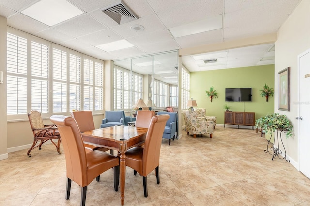 3047 S Atlantic Ave Unit 706, Daytona Beach, FL 32118 - dining space featuring plenty of natural light, a paneled ceiling, and light tile patterned floors