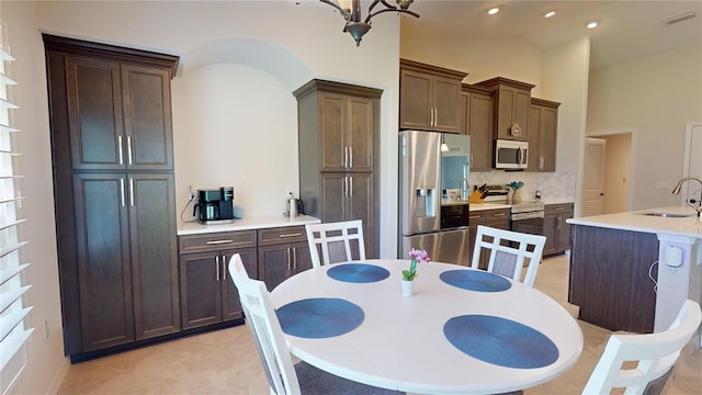 90 Randolph Dr, Palm Coast, FL 32164 - dining room with lofted ceiling, light tile patterned floors, and recessed lighting