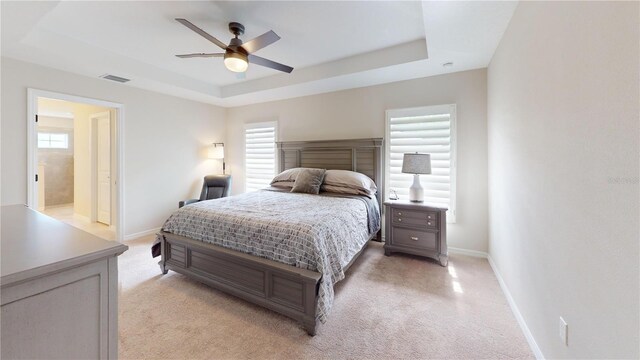 90 Randolph Dr, Palm Coast, FL 32164 - bedroom featuring a raised ceiling, light colored carpet, multiple windows, and a ceiling fan