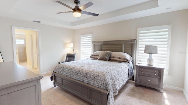90 Randolph Dr, Palm Coast, FL 32164 - bedroom with a tray ceiling, light carpet, and a ceiling fan