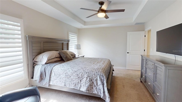 90 Randolph Dr, Palm Coast, FL 32164 - bedroom featuring a tray ceiling, light carpet, and ceiling fan
