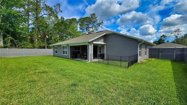 90 Randolph Dr, Palm Coast, FL 32164 - back of property featuring a fenced backyard, stucco siding, and a patio area