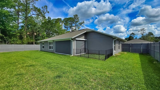 90 Randolph Dr, Palm Coast, FL 32164 - rear view of house with a fenced backyard, stucco siding, and a garage