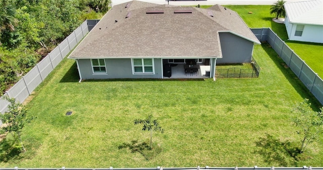 90 Randolph Dr, Palm Coast, FL 32164 - back of house with a patio area, roof with shingles, a fenced backyard, and stucco siding