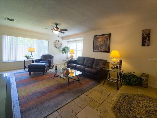 9 Collins Ln, Palm Coast, FL 32137 - living area with stone tile floors, a ceiling fan, and a textured ceiling