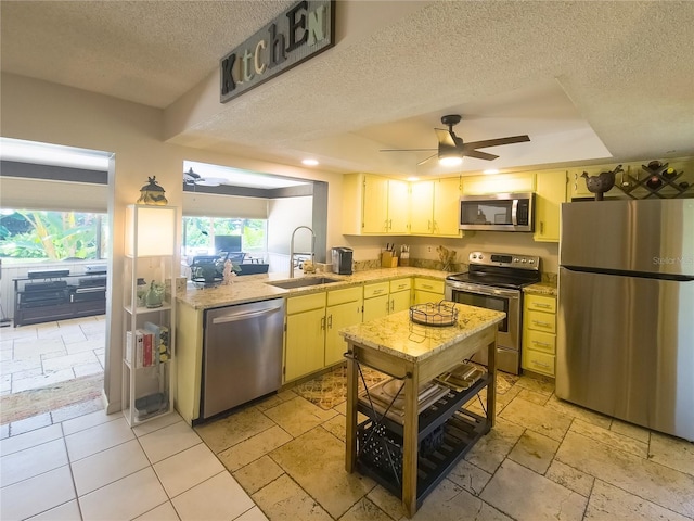 9 Collins Ln, Palm Coast, FL 32137 - kitchen with stainless steel appliances, a textured ceiling, a raised ceiling, and ceiling fan