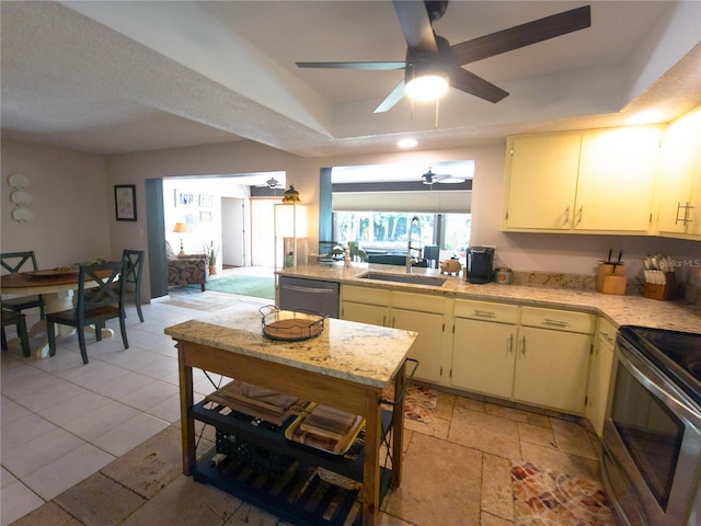 9 Collins Ln, Palm Coast, FL 32137 - kitchen featuring appliances with stainless steel finishes, light countertops, a ceiling fan, a tray ceiling, and cream cabinets