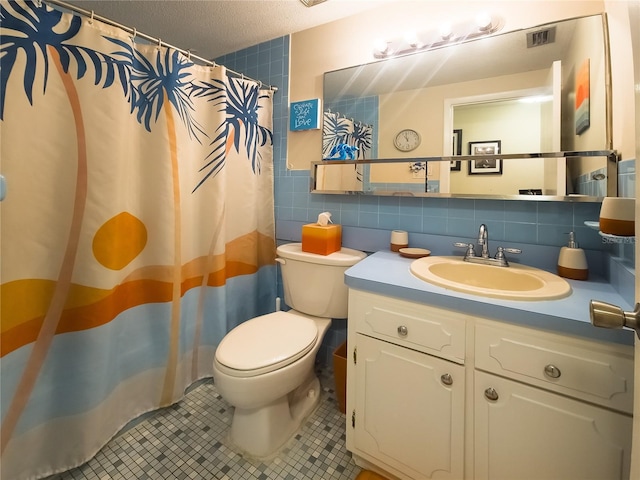 9 Collins Ln, Palm Coast, FL 32137 - bathroom featuring tile walls, vanity, tile patterned floors, a textured ceiling, and curtained shower