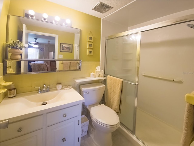 9 Collins Ln, Palm Coast, FL 32137 - bathroom featuring tile walls, a shower stall, vanity, and wainscoting