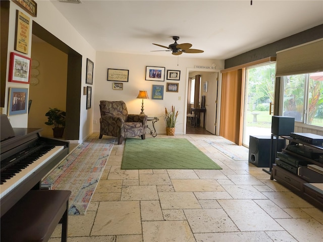 9 Collins Ln, Palm Coast, FL 32137 - living room featuring stone tile flooring and ceiling fan