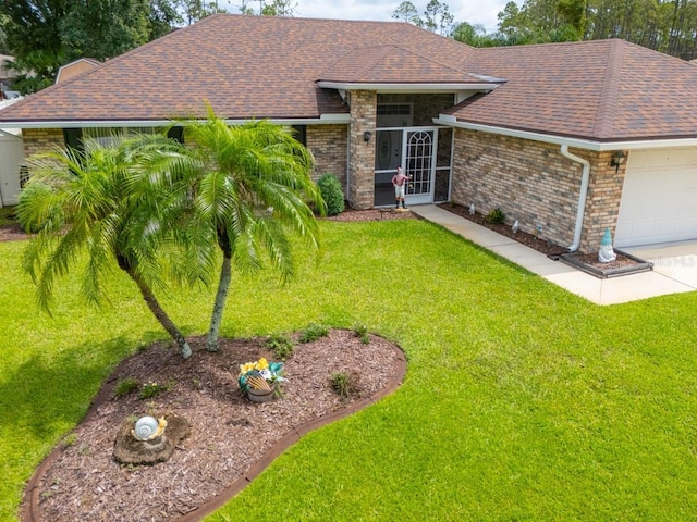 4 Essington Ln, Palm Coast, FL 32164 - view of front of home with a garage, a shingled roof, a front yard, and brick siding