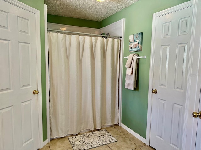 4 Essington Ln, Palm Coast, FL 32164 - full bathroom with tile patterned flooring, a textured ceiling, and a shower with curtain
