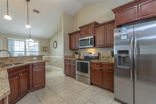 4 Essington Ln, Palm Coast, FL 32164 - kitchen featuring stainless steel appliances, vaulted ceiling, decorative light fixtures, light tile patterned floors, and light stone countertops