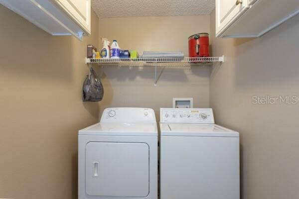 4 Essington Ln, Palm Coast, FL 32164 - laundry area with cabinet space, separate washer and dryer, and a textured ceiling