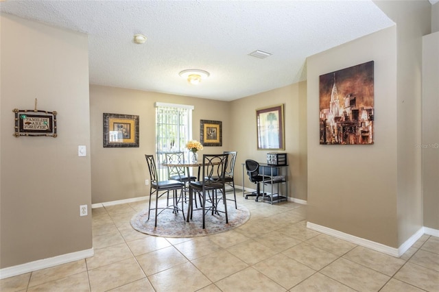 4 Essington Ln, Palm Coast, FL 32164 - dining room with light tile patterned floors and a textured ceiling