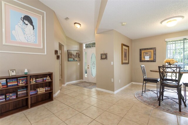 4 Essington Ln, Palm Coast, FL 32164 - foyer with a textured ceiling and light tile patterned flooring