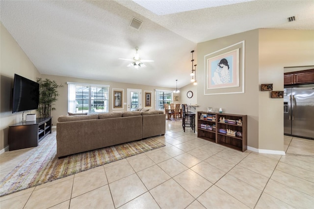 4 Essington Ln, Palm Coast, FL 32164 - living room with lofted ceiling, light tile patterned floors, ceiling fan, and a textured ceiling