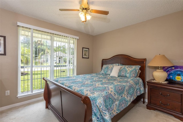 4 Essington Ln, Palm Coast, FL 32164 - bedroom featuring light carpet, multiple windows, access to outside, and a textured ceiling