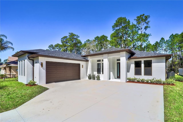 179 Eric Dr, Palm Coast, FL 32164 - prairie-style home featuring stucco siding, concrete driveway, an attached garage, and a front lawn