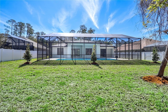 179 Eric Dr, Palm Coast, FL 32164 - rear view of property featuring a fenced backyard, glass enclosure, and a patio area