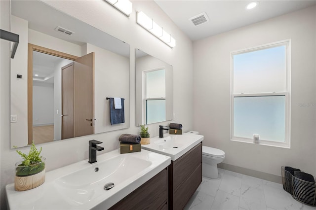 179 Eric Dr, Palm Coast, FL 32164 - bathroom with marble finish floors, vanity, healthy amount of natural light, and recessed lighting