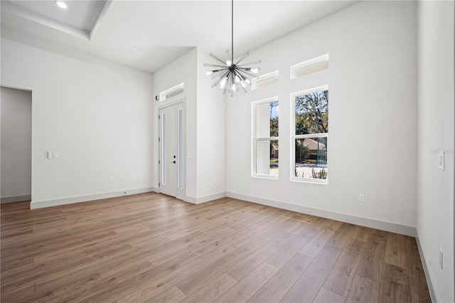 179 Eric Dr, Palm Coast, FL 32164 - spare room featuring a chandelier and light wood-type flooring
