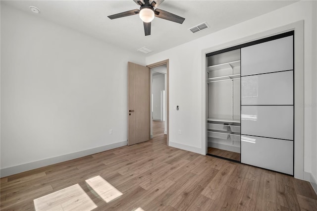 179 Eric Dr, Palm Coast, FL 32164 - unfurnished bedroom with light wood finished floors, a closet, and a ceiling fan
