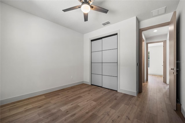 179 Eric Dr, Palm Coast, FL 32164 - unfurnished bedroom featuring wood finished floors, a closet, a ceiling fan, and recessed lighting