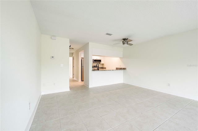 3630 S Central Ave, Flagler Beach, FL 32136 - unfurnished living room featuring a ceiling fan and light tile patterned flooring
