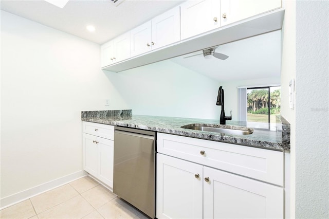 3630 S Central Ave, Flagler Beach, FL 32136 - kitchen with dishwasher, light tile patterned floors, dark stone countertops, and white cabinetry
