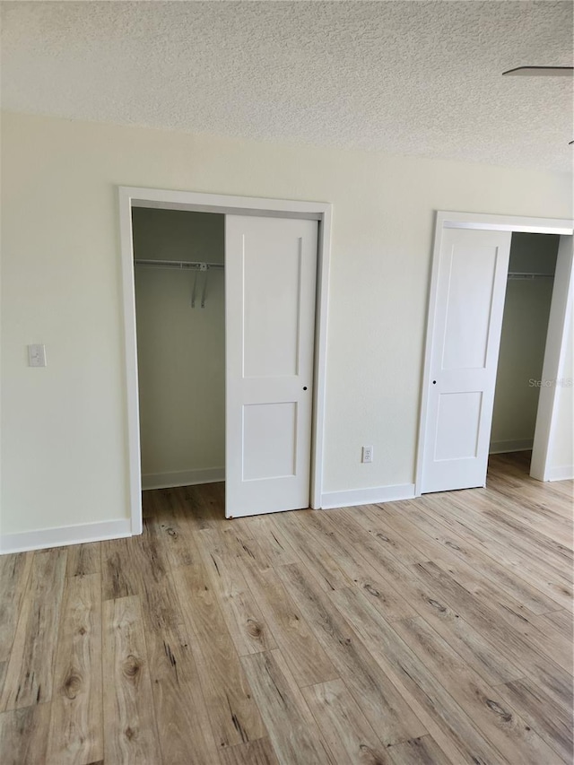 3630 S Central Ave, Flagler Beach, FL 32136 - unfurnished bedroom with wood finished floors, a textured ceiling, and a closet