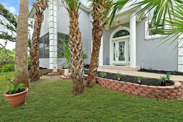 101 N 22nd St, Flagler Beach, FL 32136 - entrance to property with stucco siding and a lawn