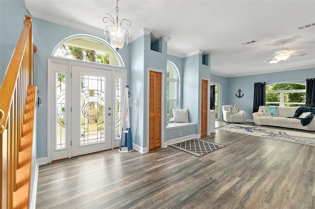 101 N 22nd St, Flagler Beach, FL 32136 - foyer with wood finished floors, ornamental molding, ceiling fan, and a chandelier