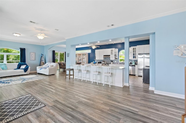 101 N 22nd St, Flagler Beach, FL 32136 - living area with ceiling fan, crown molding, plenty of natural light, light wood-type flooring, and recessed lighting