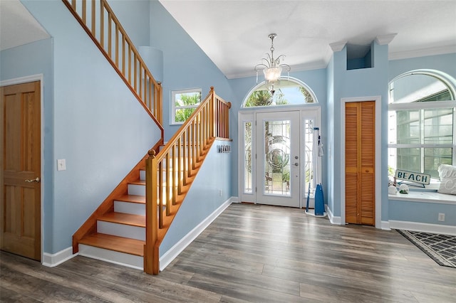 101 N 22nd St, Flagler Beach, FL 32136 - entryway featuring crown molding, stairway, wood finished floors, a chandelier, and a high ceiling