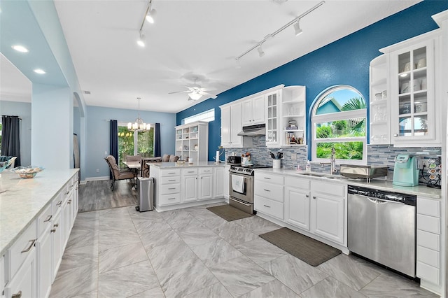 101 N 22nd St, Flagler Beach, FL 32136 - kitchen with stainless steel appliances, under cabinet range hood, open shelves, a peninsula, and rail lighting