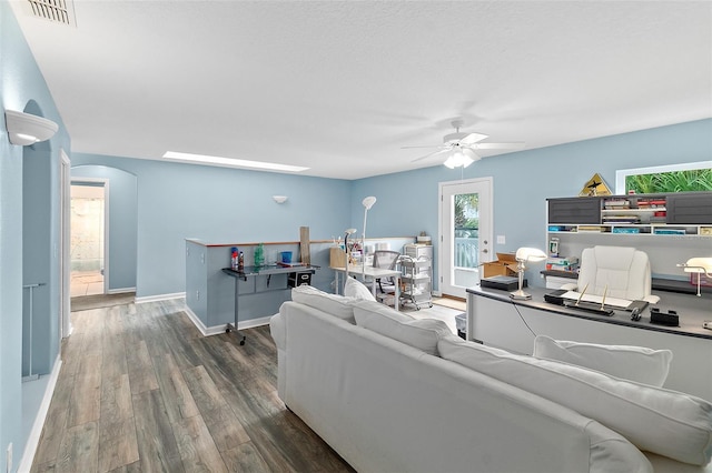 101 N 22nd St, Flagler Beach, FL 32136 - living area with a ceiling fan, arched walkways, wood finished floors, and an office area