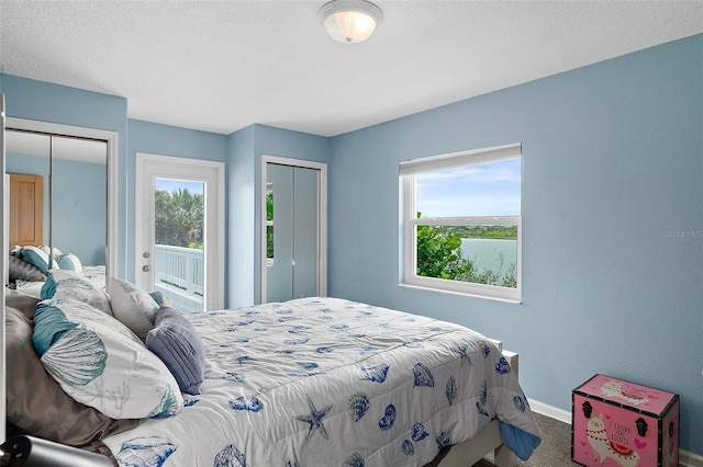 101 N 22nd St, Flagler Beach, FL 32136 - carpeted bedroom featuring two closets and multiple windows