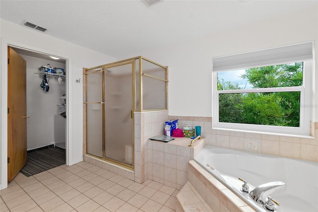 101 N 22nd St, Flagler Beach, FL 32136 - bathroom with a stall shower, a garden tub, tile patterned floors, and a walk in closet