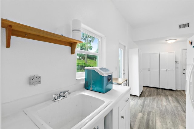 101 N 22nd St, Flagler Beach, FL 32136 - laundry area featuring a sink and light wood-style floors