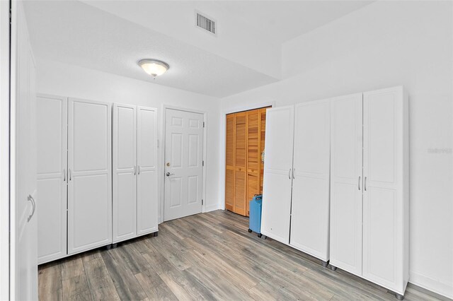 101 N 22nd St, Flagler Beach, FL 32136 - unfurnished bedroom with wood finished floors and two closets