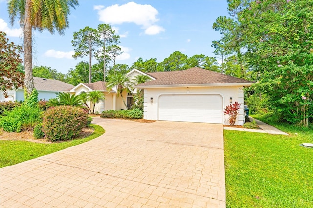 68 Egret Trl, Palm Coast, FL 32164 - single story home with decorative driveway, stucco siding, a front yard, and a garage