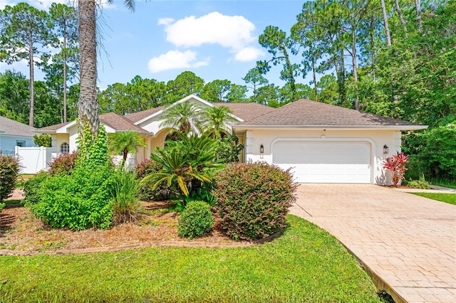 68 Egret Trl, Palm Coast, FL 32164 - ranch-style home featuring stucco siding, decorative driveway, and an attached garage