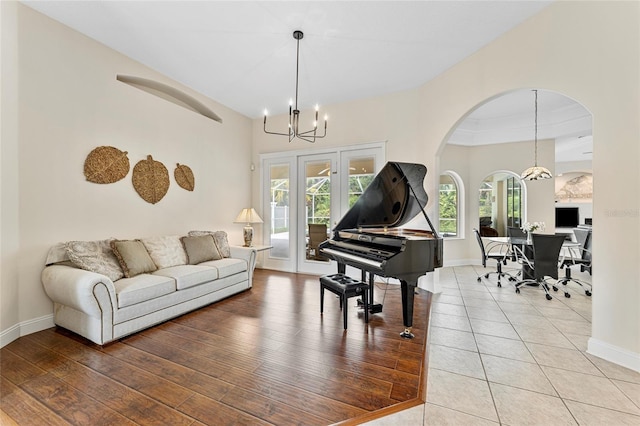68 Egret Trl, Palm Coast, FL 32164 - tiled living area with a chandelier, french doors, and arched walkways