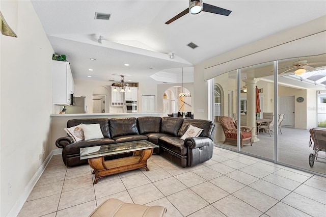 68 Egret Trl, Palm Coast, FL 32164 - living room with a ceiling fan, arched walkways, lofted ceiling, light tile patterned flooring, and a chandelier